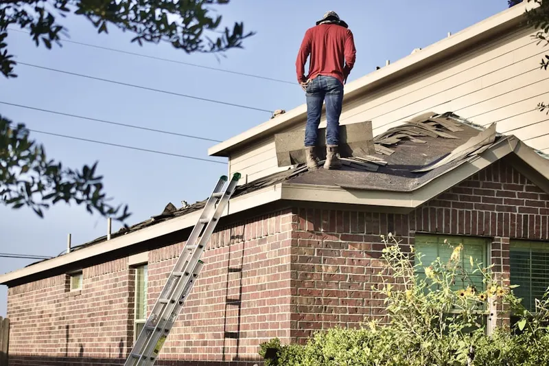 Professional roofer working on a residential roof in Sienna